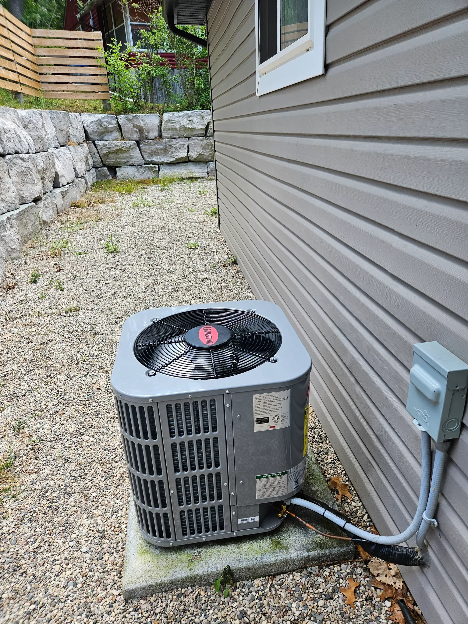 New central air conditioner condenser unit installed by Corner Gas HVAC beside a London Ontario home